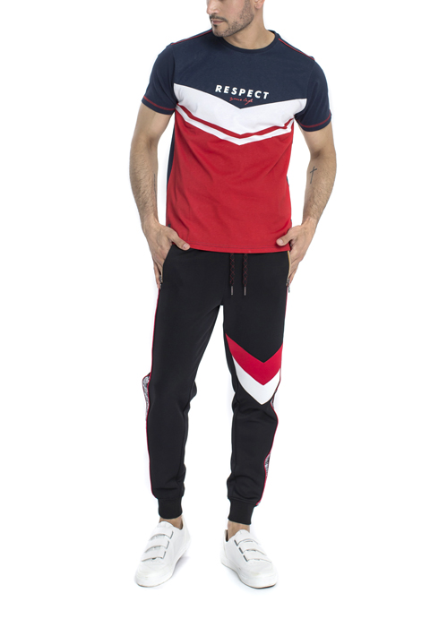 Model wearing Respect design printed logo with blue white and red shirt with black jogger pants.