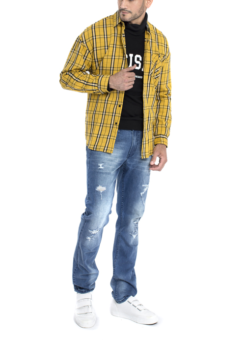 Model wearing yellow jacket with blue jeans.