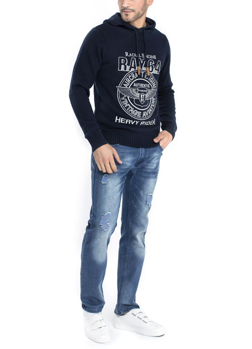 Model wearing hooded sweater with blue jeans.