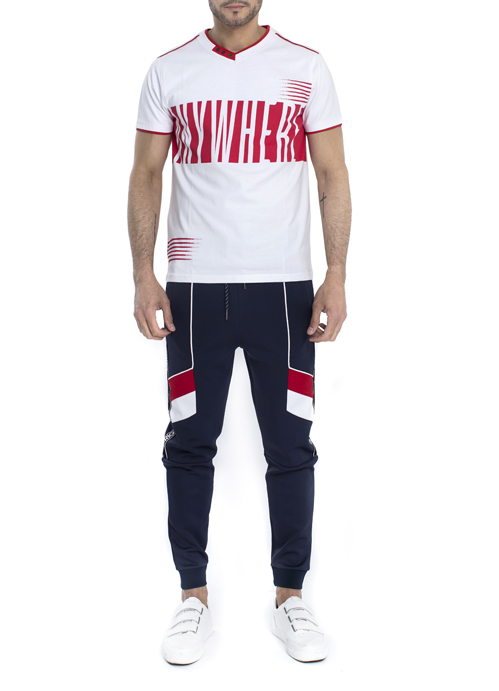 Model wearing whie and red design shirt with blak jogger pants.