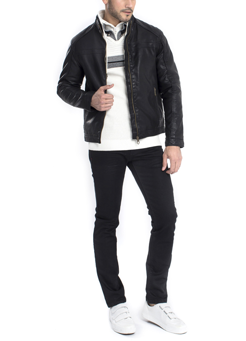 Model wearing black leather jacket and white sweater with black skinny pants.