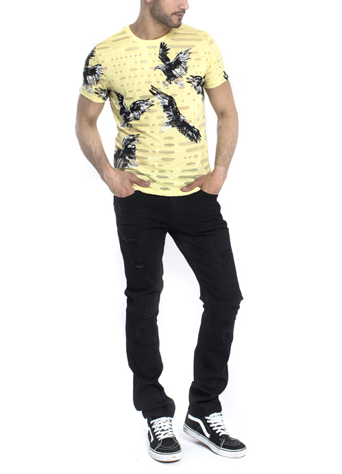 Model wearing light yellow with eagle printed shirt with black pants.