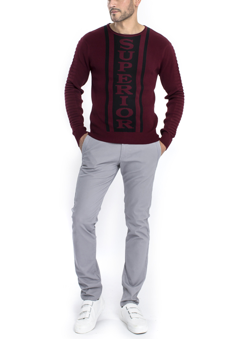 Model wearing dark red shirt and superior design with grey chino pants.