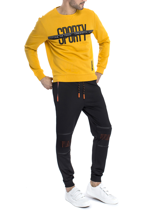 Model wearing Sporty design long sleeve shirt with black jogger pants.