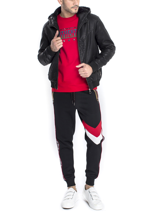 Model wearing black leather jacket and red shirt with black jogger pants.