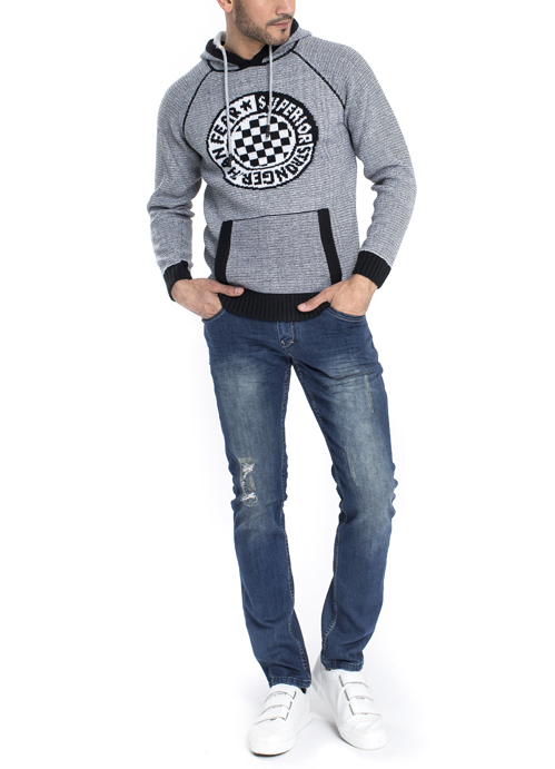 Model wearing grey design hoodie with blue jeans.