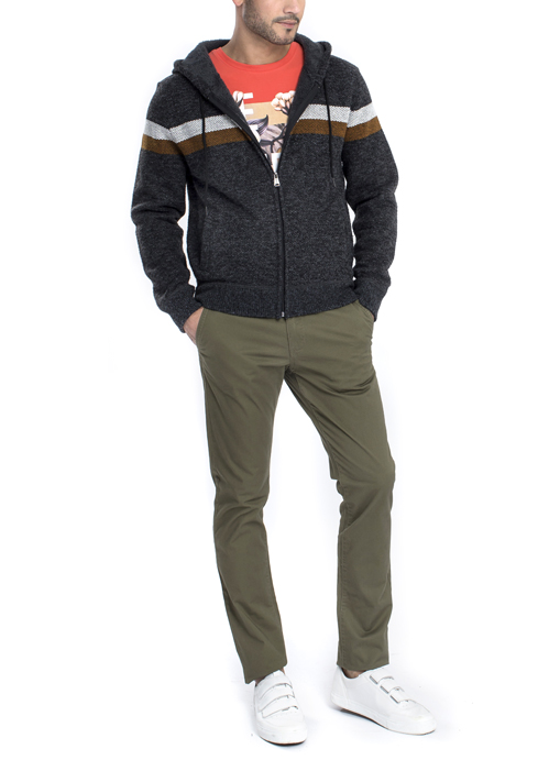 Model wearing dark grey zip hoodie jacket with brown chino pants.