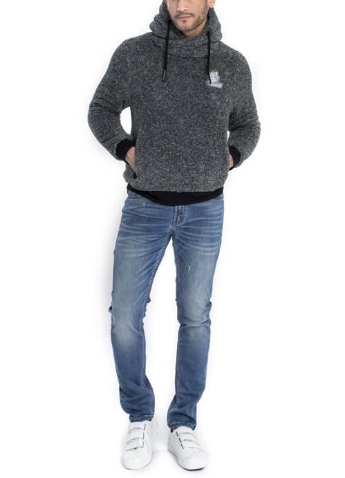 Model wearing dark grey sweater with blue jeans.