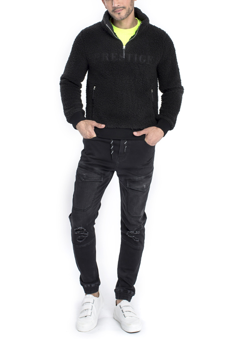 Model wearing black sweater with black jeans.